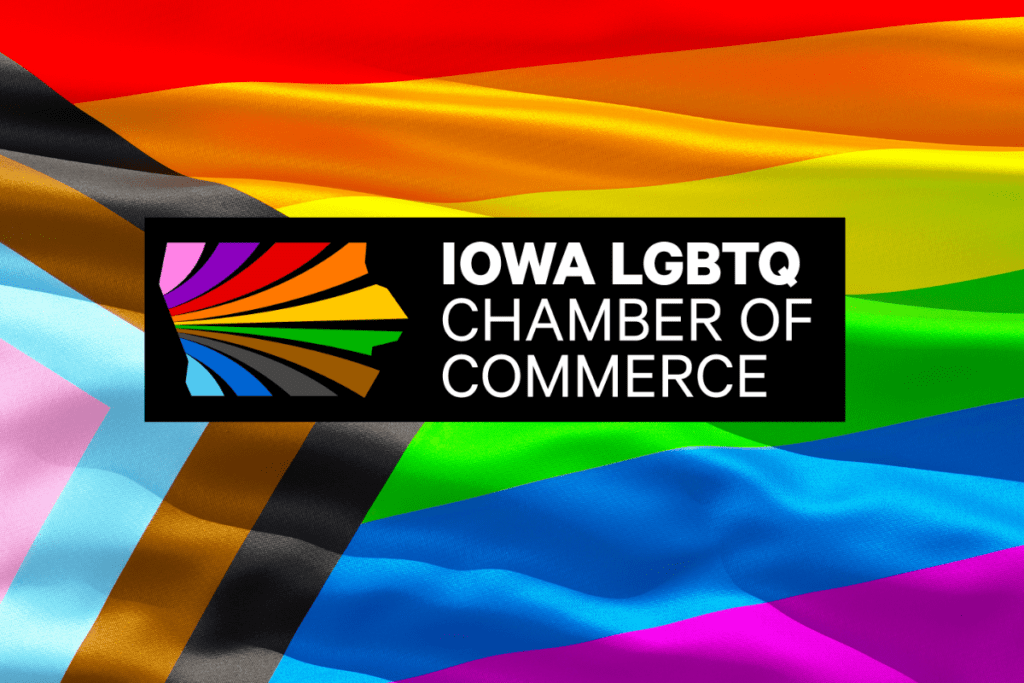 The Iowa LGBTQ Chamber of Commerce Logo, which includes a pride flag in the shape of Iowa next to the organization's name, on top of a Progress Pride Flag.