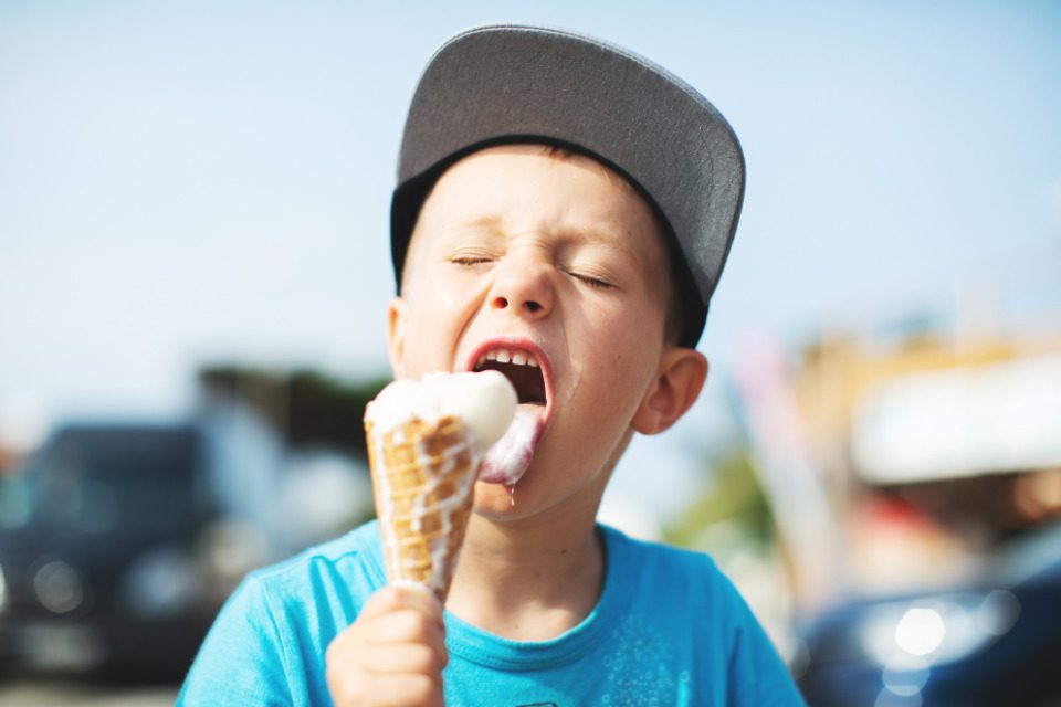 A boy eating an ice cream cone.