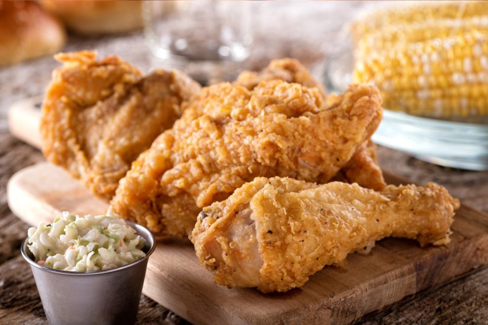 Fried chicken platter with corn on the cob and slaw.