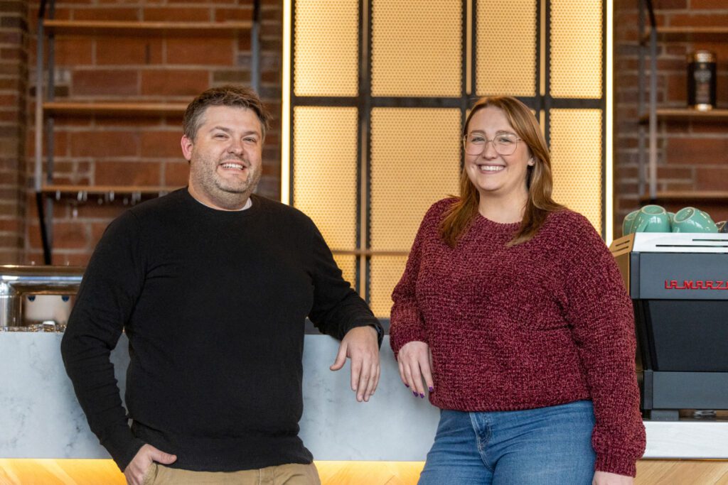 Tony Tandeski (left) and Annelise Tarnowki (right), owners of the Rook Room stand at the counter of what will be the new lounge and cafe where people can play boardgames and socialize.